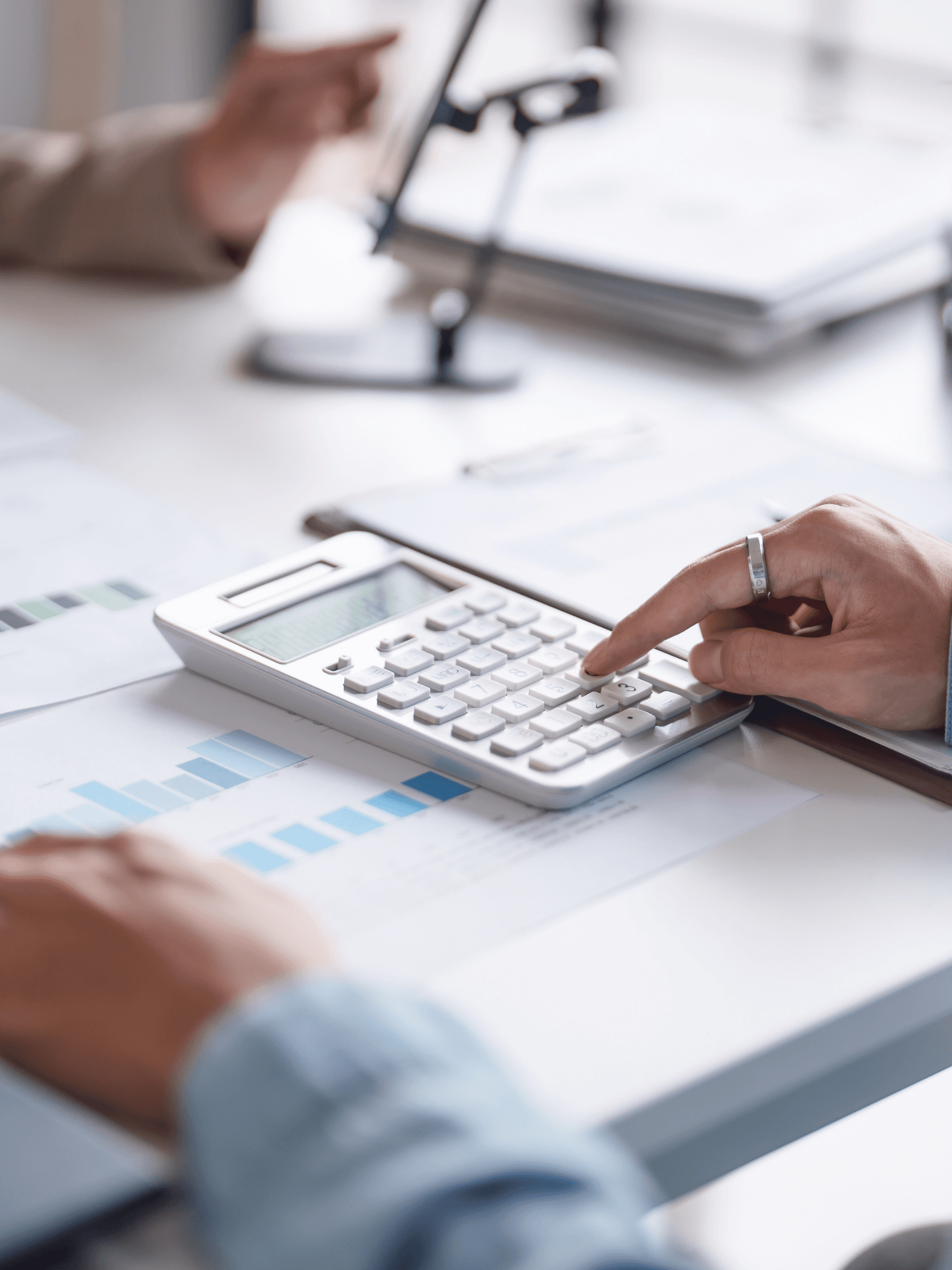 Close-up of financial calculations with printed charts and a calculator