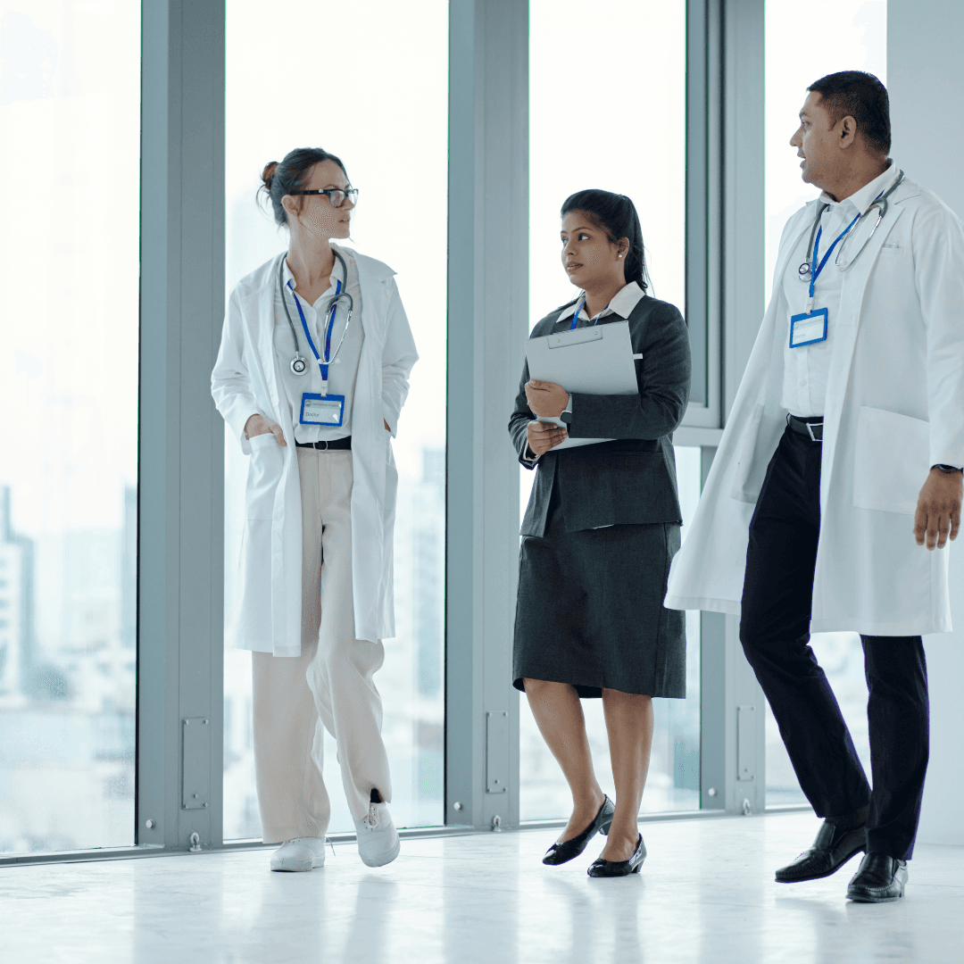 Healthcare professionals walking and collaborating in a bright modern hallway